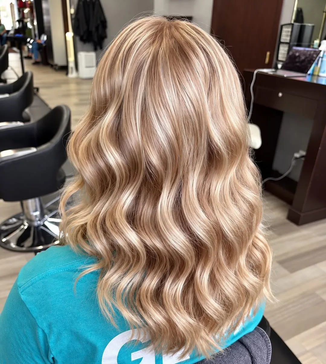 Long blonde hair styled in soft waves, rear view